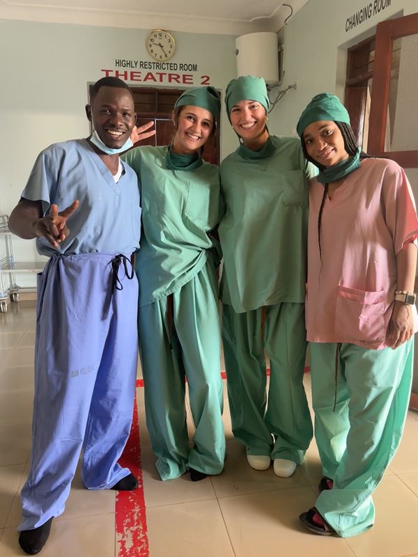 Tania Thomas, College of Pharmacy student (right), posing with colleagues in Uganda during a global health project. 