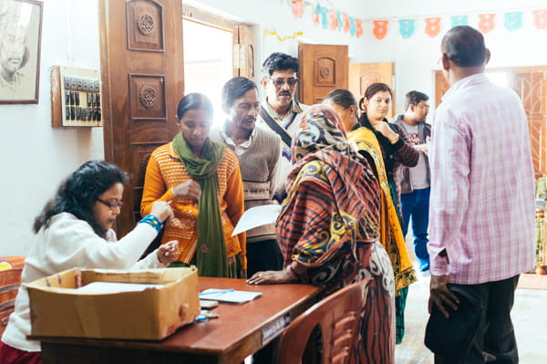 Indian clinic staff assist patients.