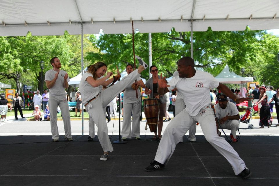 A man and a woman conduct a martial arts demonstration. 