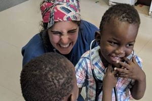 MUSC student plays with Tanzanian children.