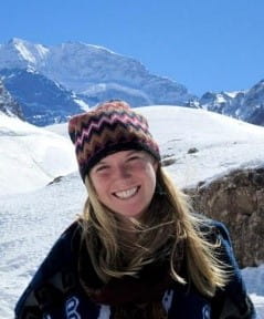 A headshot of Caroline West in the mountains