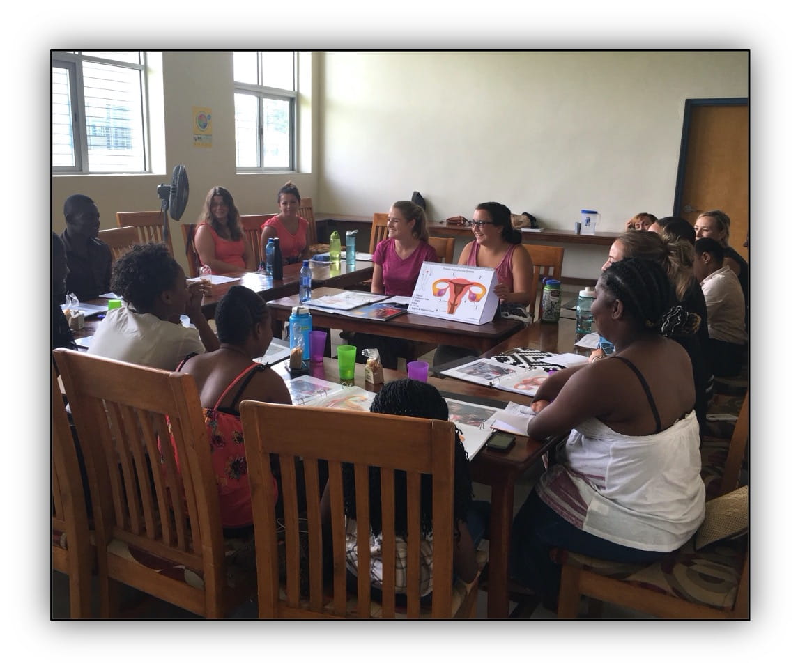 Volunteers and students work with Days for Girls in Haiti.