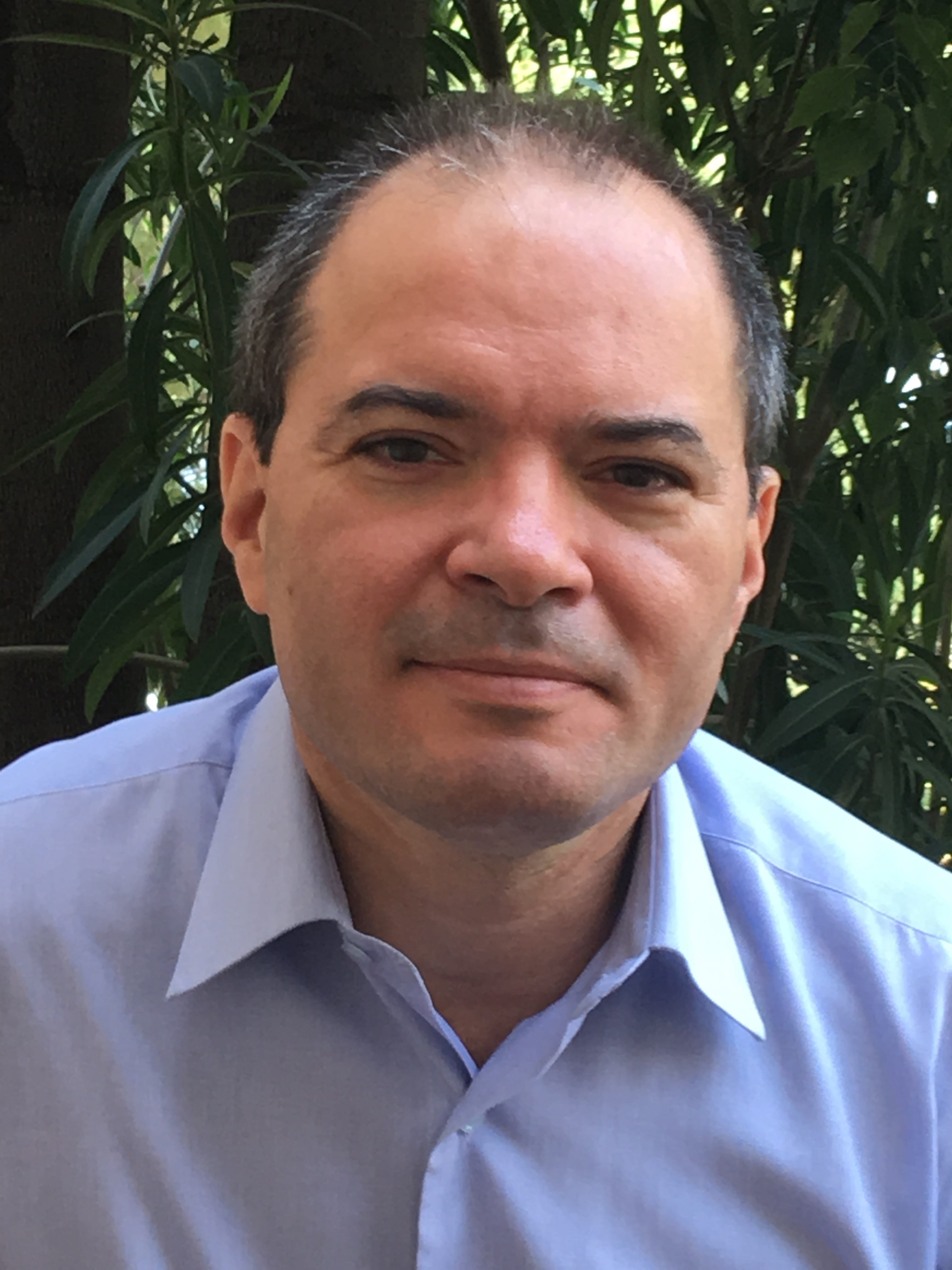 Headshot of Samer.
