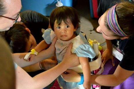 A MUSC occupational therapy student assists a child in Nicaragua.