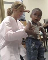 Patty Coker Bolt examines a child patient.