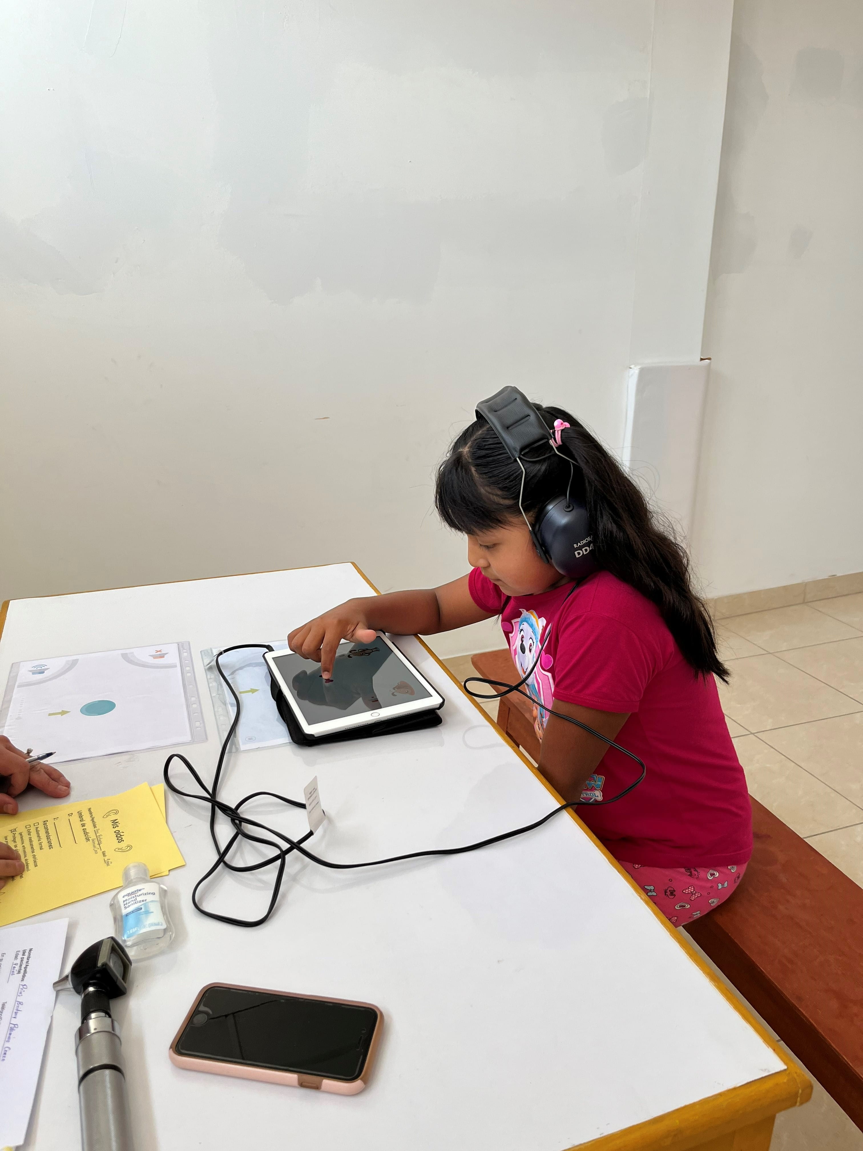 A child takes a hearing test in Peru.