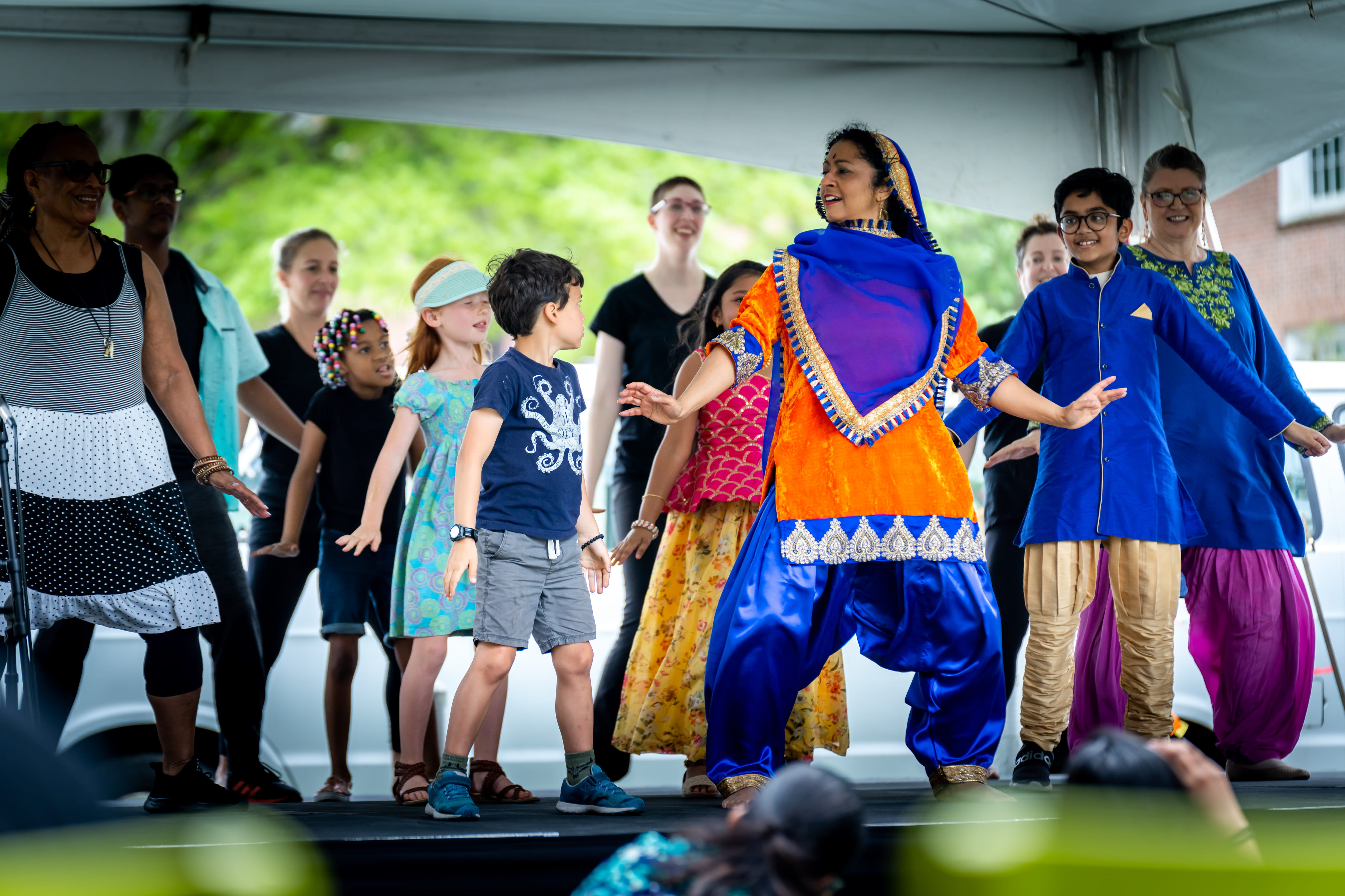 A Sri Lankan dance is performed with crowd members at the International Bazaar.