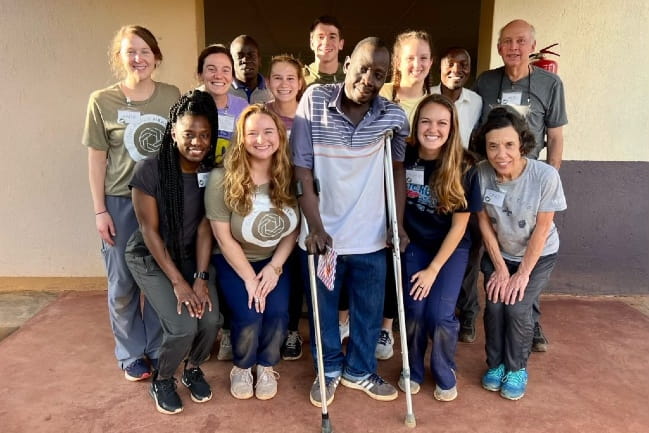 MUSC students in Uganda pose with a patient.