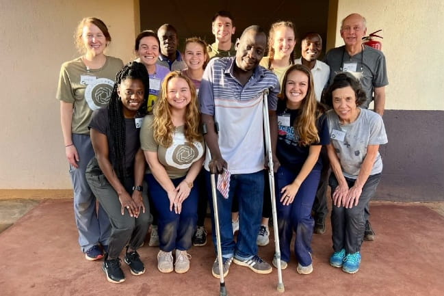 MUSC students in Uganda pose with a patient.