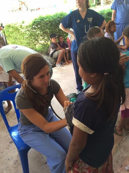 Victoria Way conducts a health exam in Thailand.