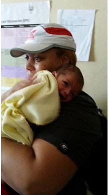 A woman holds a baby in Honduras.