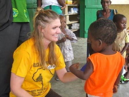 MUSC student Sarah Logan assists a child.