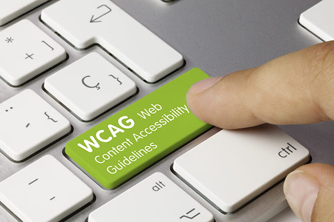 finger pointing at green wcag key on keyboard