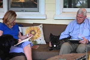 Dr. David Cole and Kathy Cole practicing social distancing with their two dogs