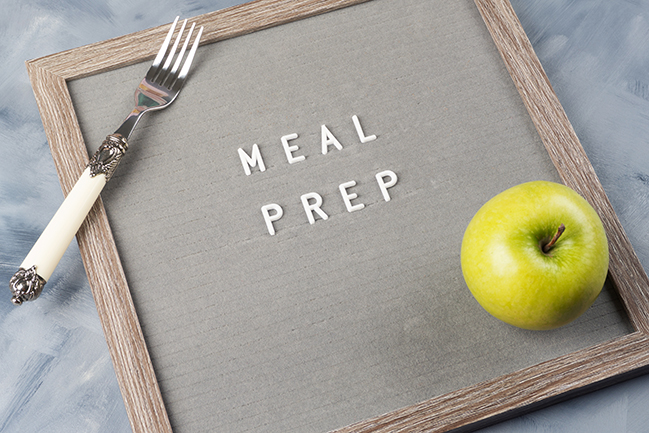 Meal prep concept with letter board, green apple and fork