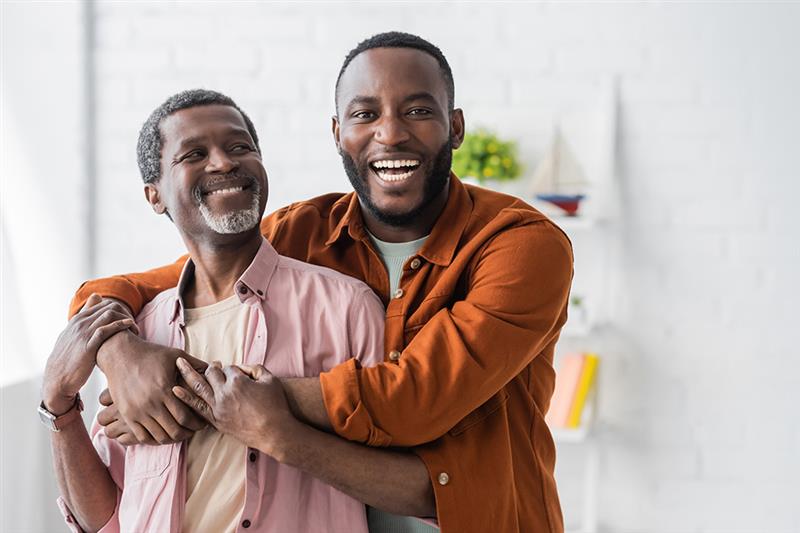 A father and son hugging after getting results from In Our DNA. 