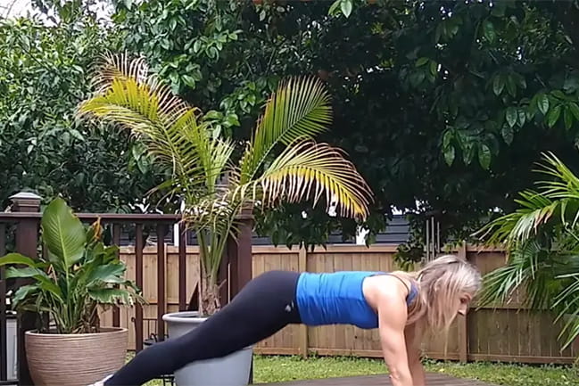 Woman doing plank pose outside