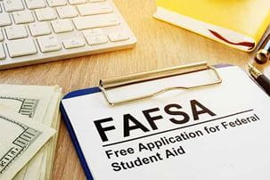 Free Application for Federal Student Aid attached to a clipboard