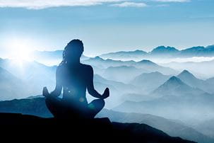 Silhouette of a woman meditating