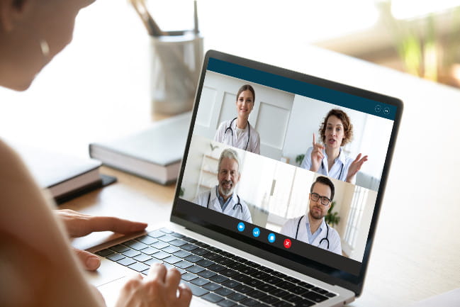 A person speaks with doctors on a virtual call.