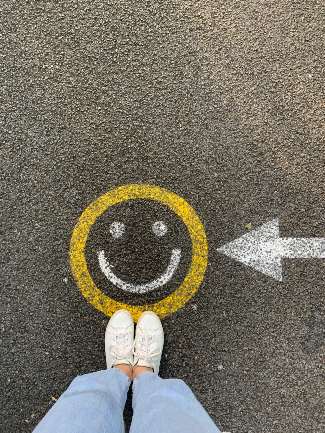 An image of a smiley face and arrow painted on the concrete.