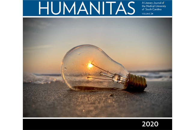 Humanitas 2020 Volume 24 magazine cover, image of light bulb on beach with sunset shining through
