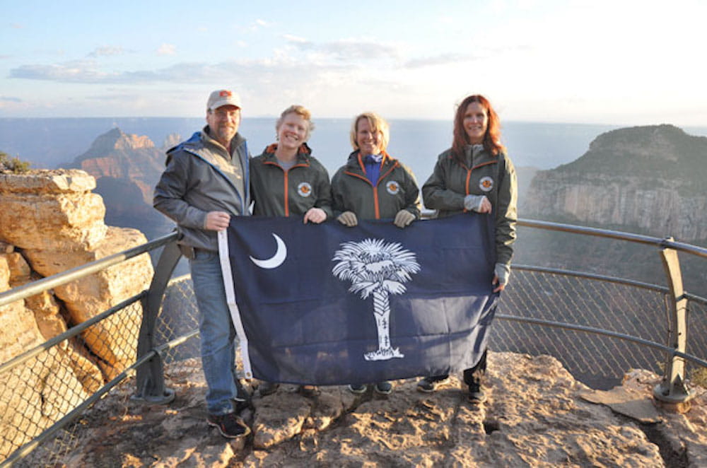 Scott Woods, Sandi Woods, Bonnie Ciuffo and Beth Jaskiewicz proudly hold the South Carolina flag at the top of the Grand Canyon