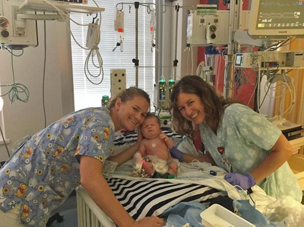 Nurses with baby in ICU