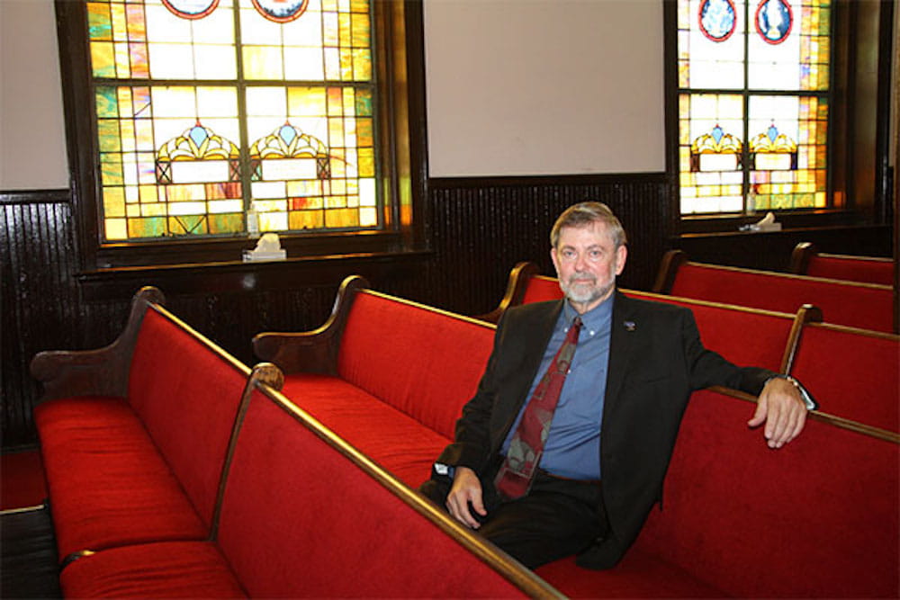 Dr. Dean Kilpatrick sitting on a pew in Mother Emauel Church