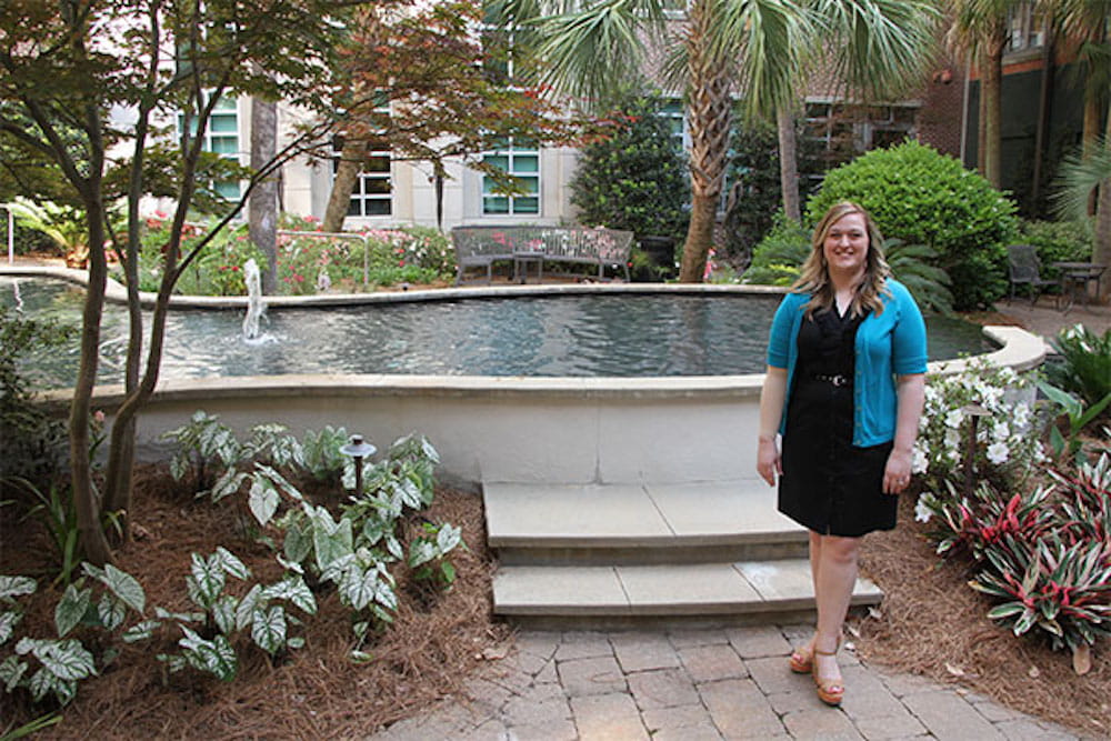 Dr. Dominiak standing in front of pond
