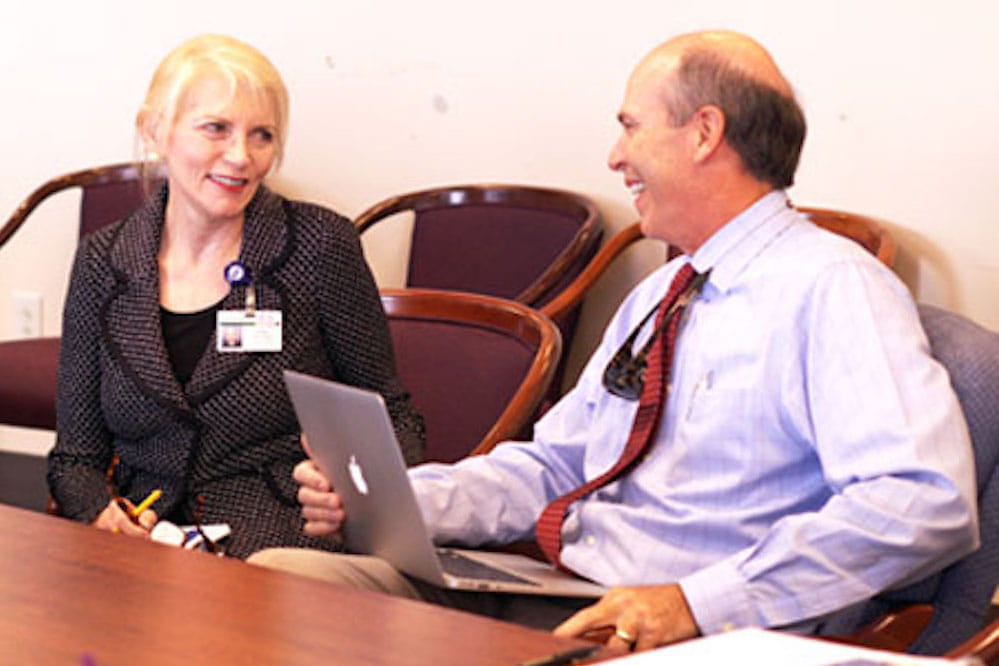 Dr. Darlene Shaw and David McNair in a conference room