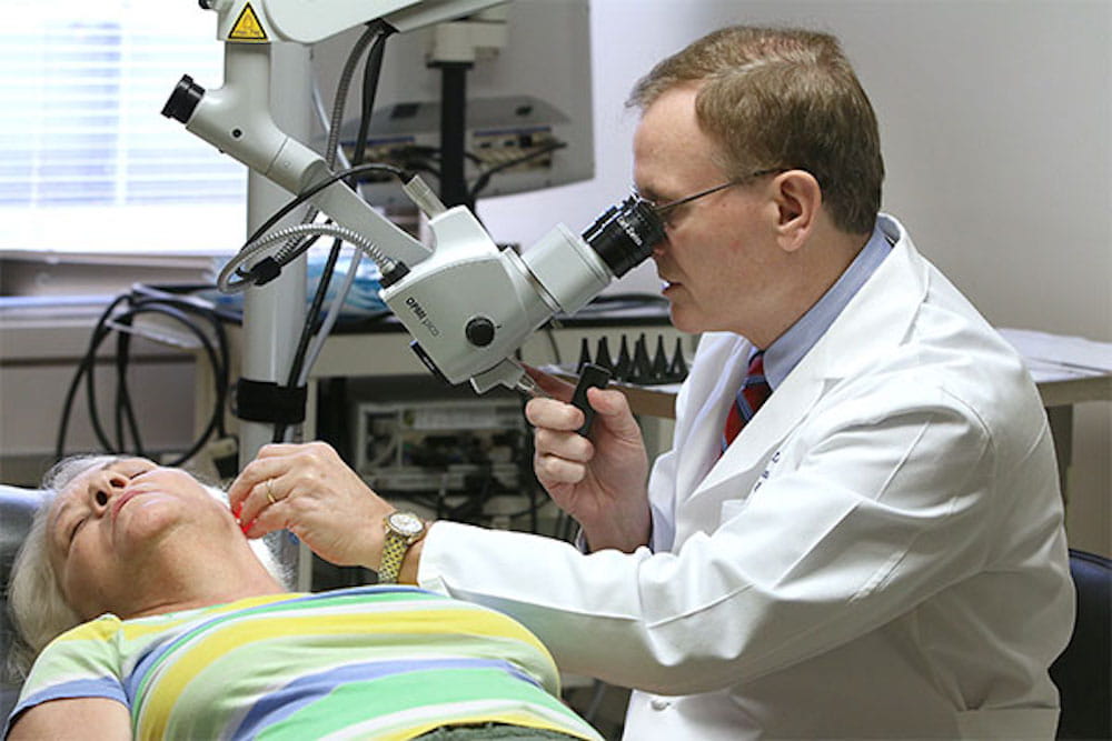 Dr. Paul Lambert examining a patient