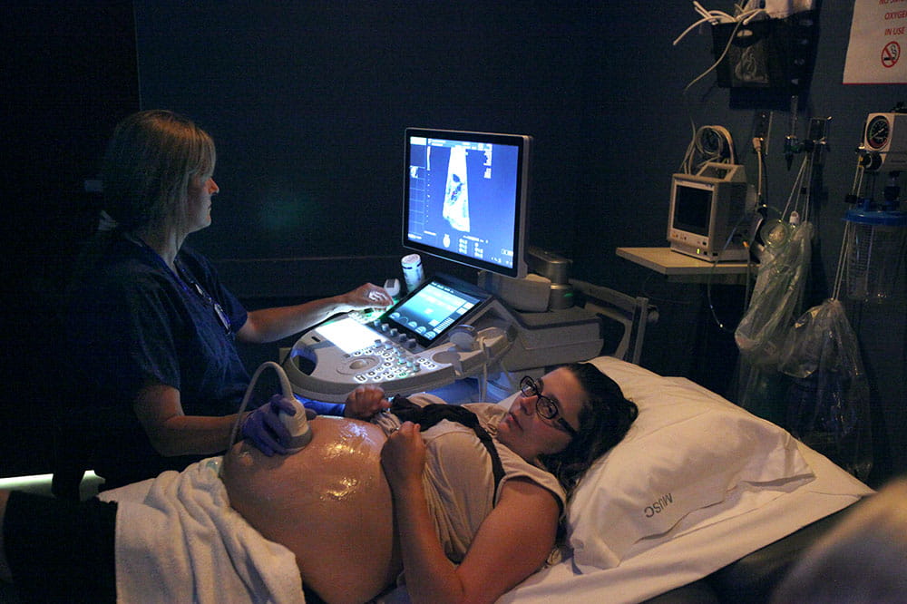 Sonographer Tammy Churchill works with patient Miranda Pace