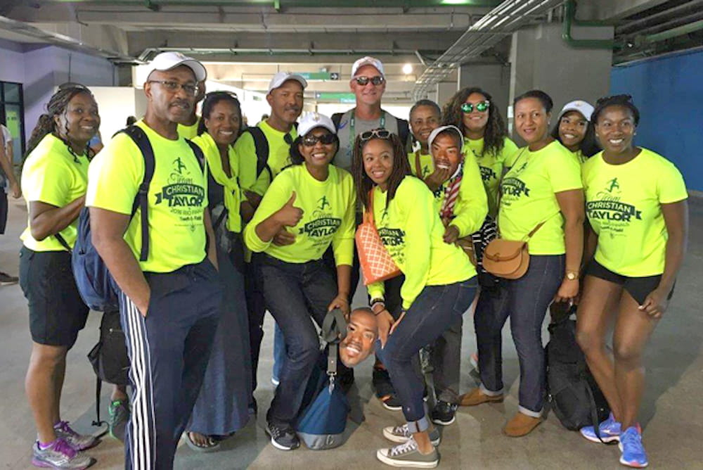 Stephanie Taylor, fourth from left, surrounded by friends, family and son Christian’s coach, Rana Reider, back center, watch Christian Taylor compete in Rio de Janero, Brazil.