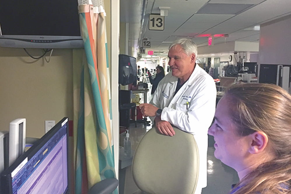 MUSC President Dr. David Cole checks on a young patient