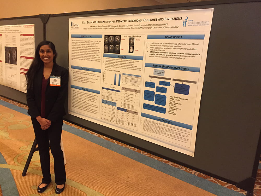 Avni Patel stands in front of her poster 