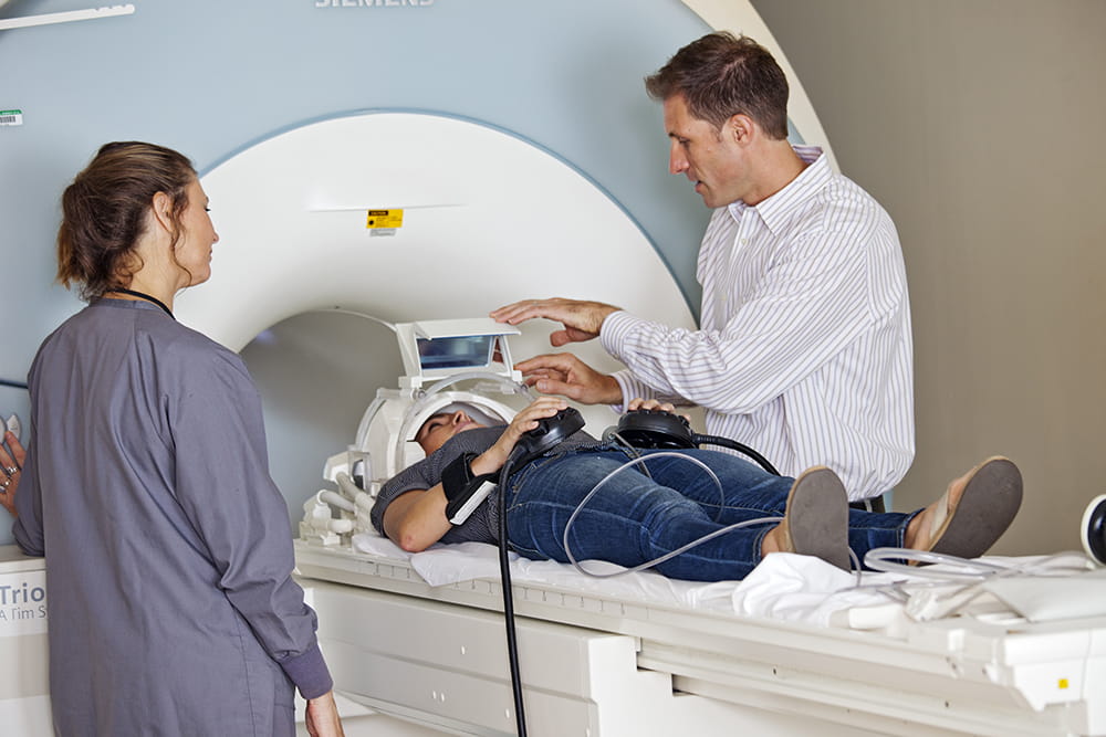 Dr. Brett Froeliger speaks to a patient about to go into an MRI machine. 