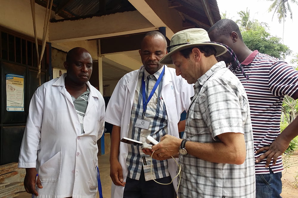 An American doctor speaks with African doctors in Tanzania