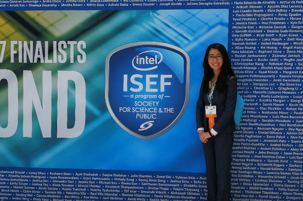 Yao stands in front of an Intel sign