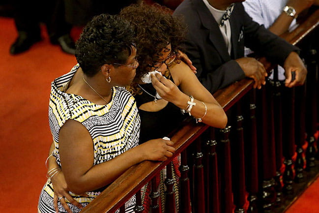 MUSC's Carla Jones consoles her daughter, Nikki Croker, as they return to Mother Emanuel AME Church four days after a white supremacist murdered nine people there.