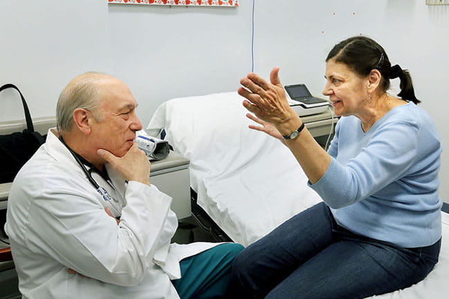Dr. Michael Zile talks with Mary Jane Lipinski, who has traveled from Virginia to MUSC to take part in a clinical trial. Photo by Brad Nettles. Used here with permission from The Post and Courier.