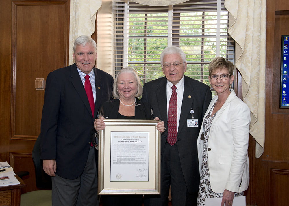 College of Nursing Dean Gail Stuart, second from left, was presented with a citation honoring her service to MUSC by MUSC President David Cole, Board of Trustees member William Bingham and Provost Dr. Lisa Saladin.
