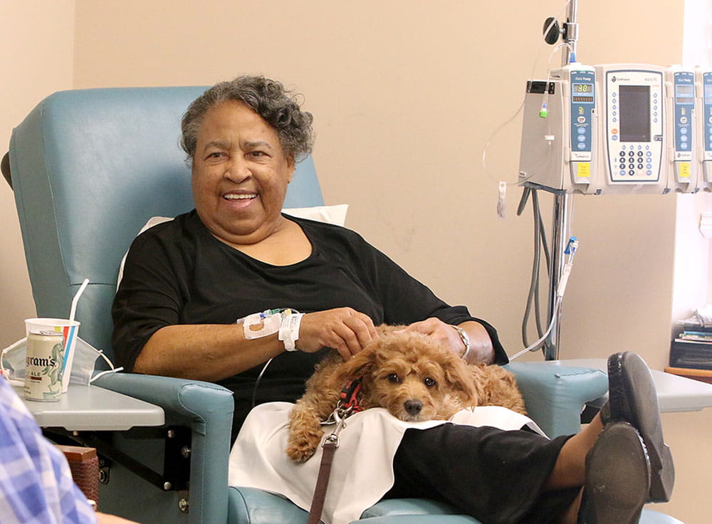 Rosalind Rivers pets one of MUSC's pet therapy dogs