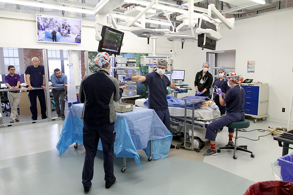 People watch a simulated operation 