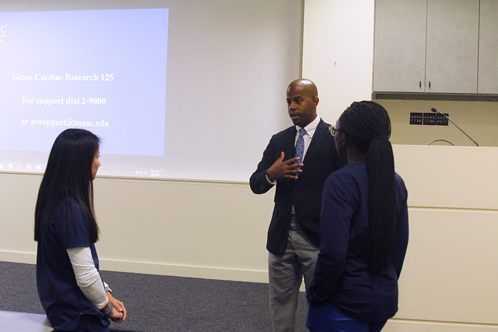 Julius Hamilton talks to two students