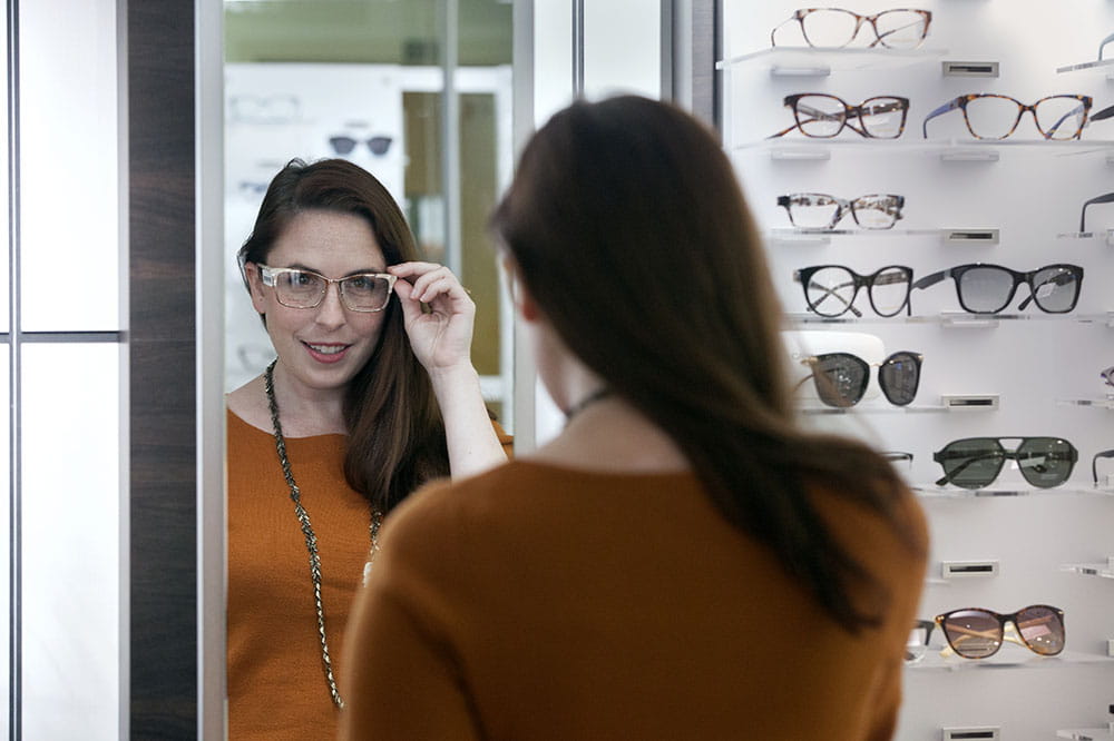 woman trying on eyeglasses