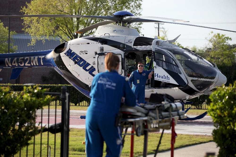 Flight paramedics bring a patient to MEDUCARE One.