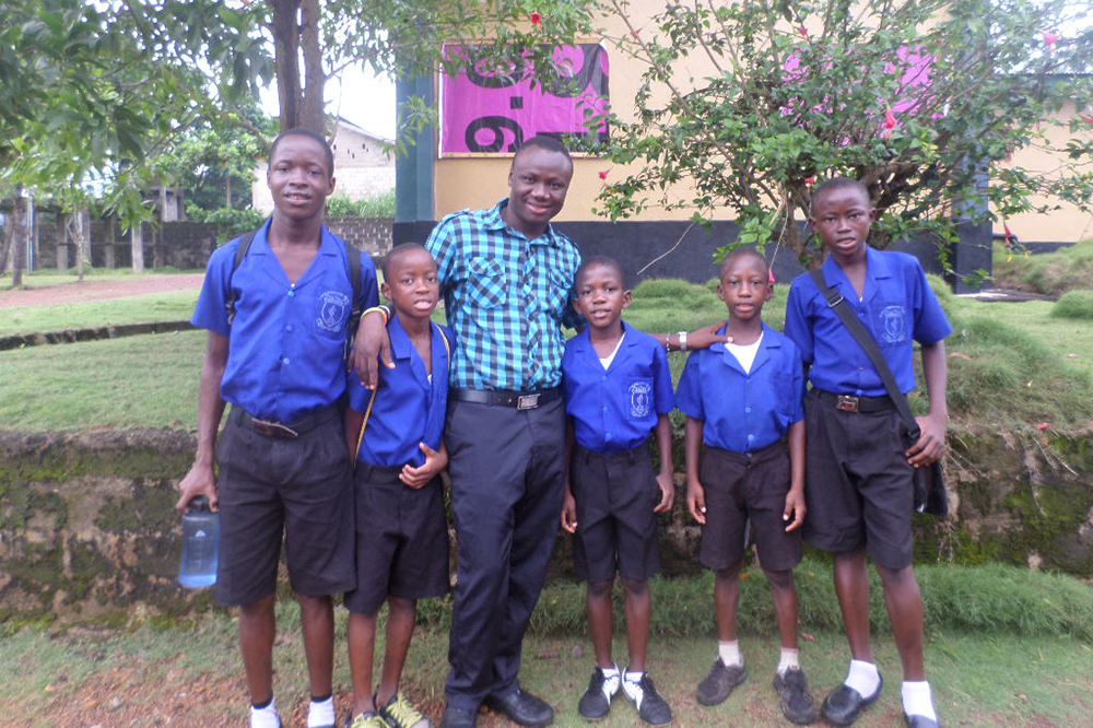 Mohamed Nabieu and five boys in school uniforms