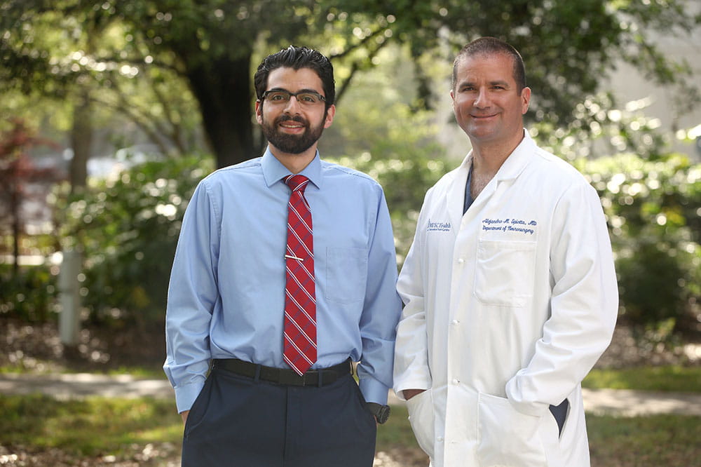 M.D./Ph.D. graduate Ali Alawieh, left, is joined by his clinical mentor, Dr. Alejandro Spiotta. Photo by Sarah Pack