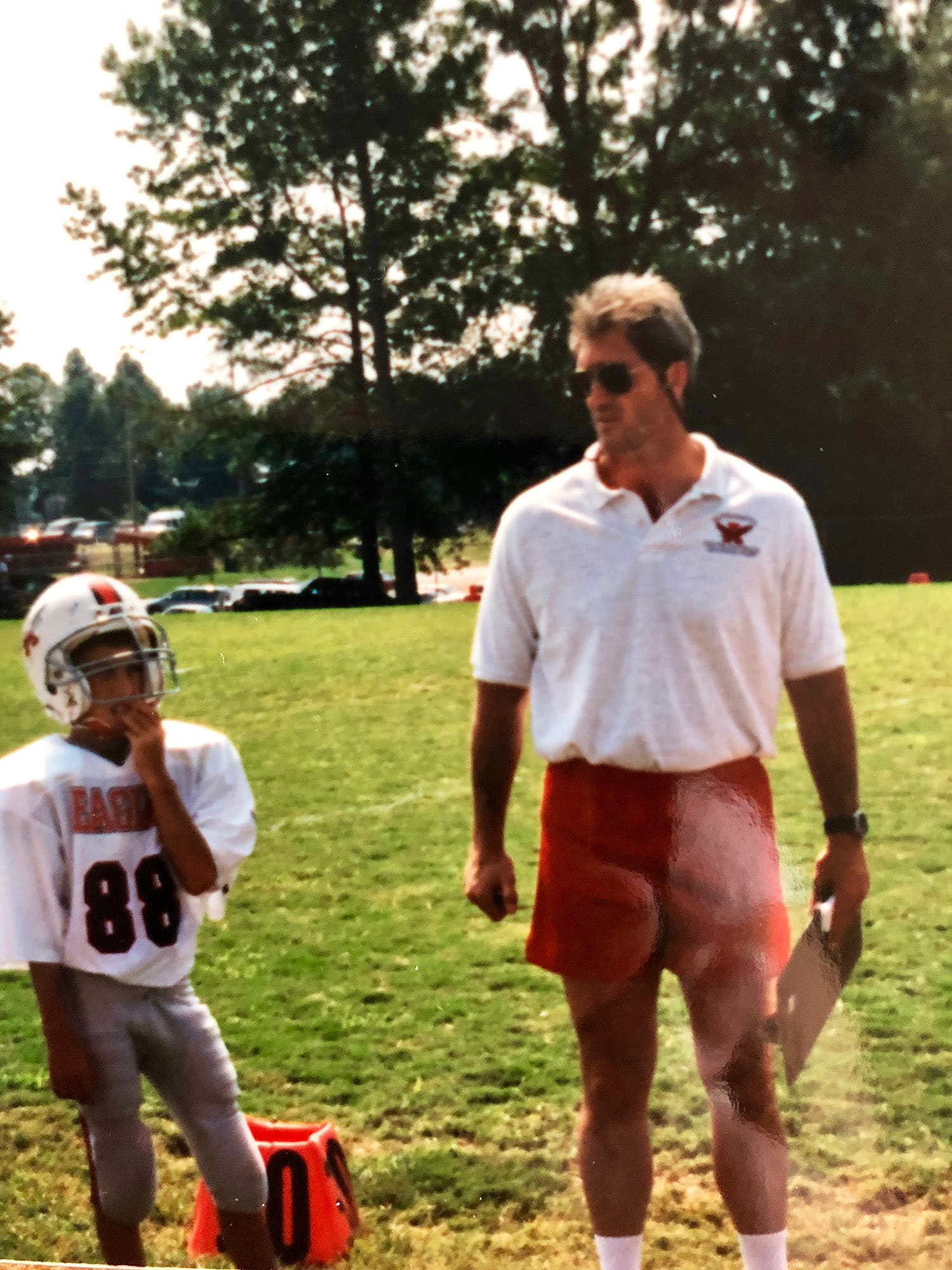 Harper with his dad, Jeff, during youth football practice.